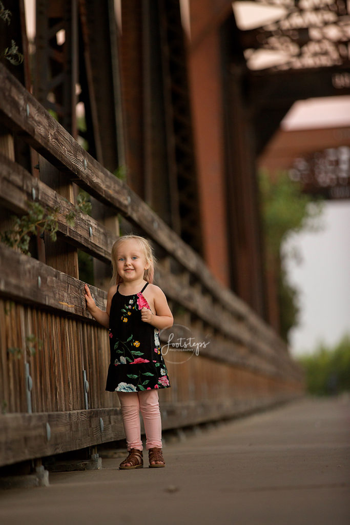 child standing on bridge in winters california