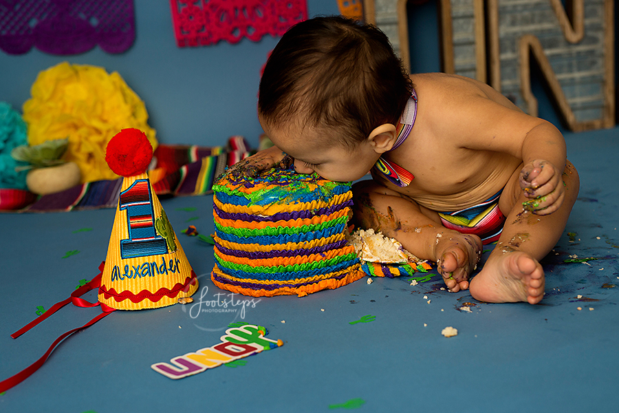 Baby eating his birthday cake face first