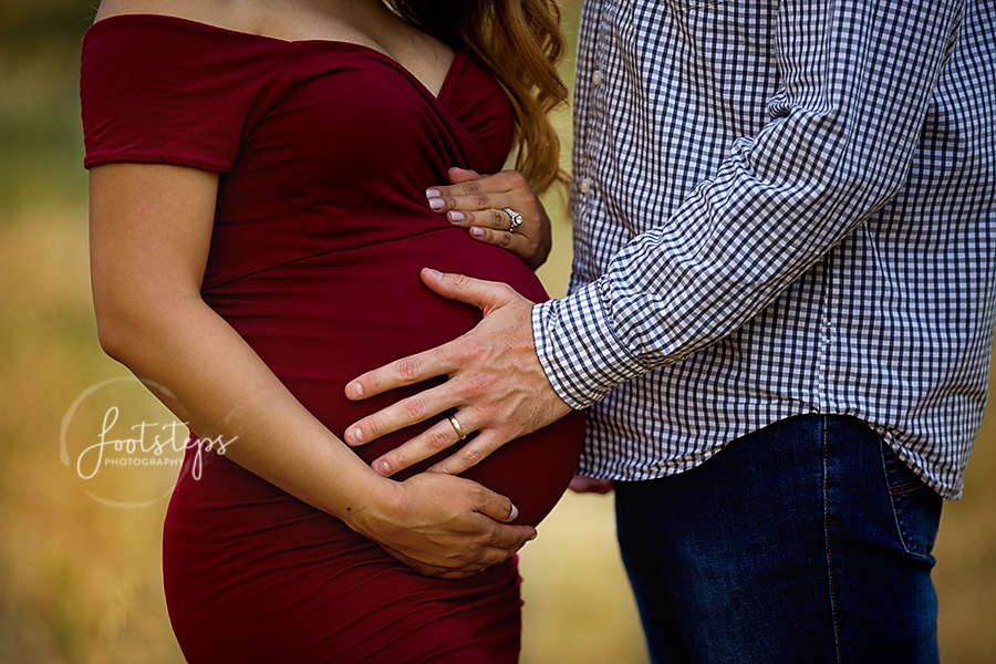 couple holding moms belly