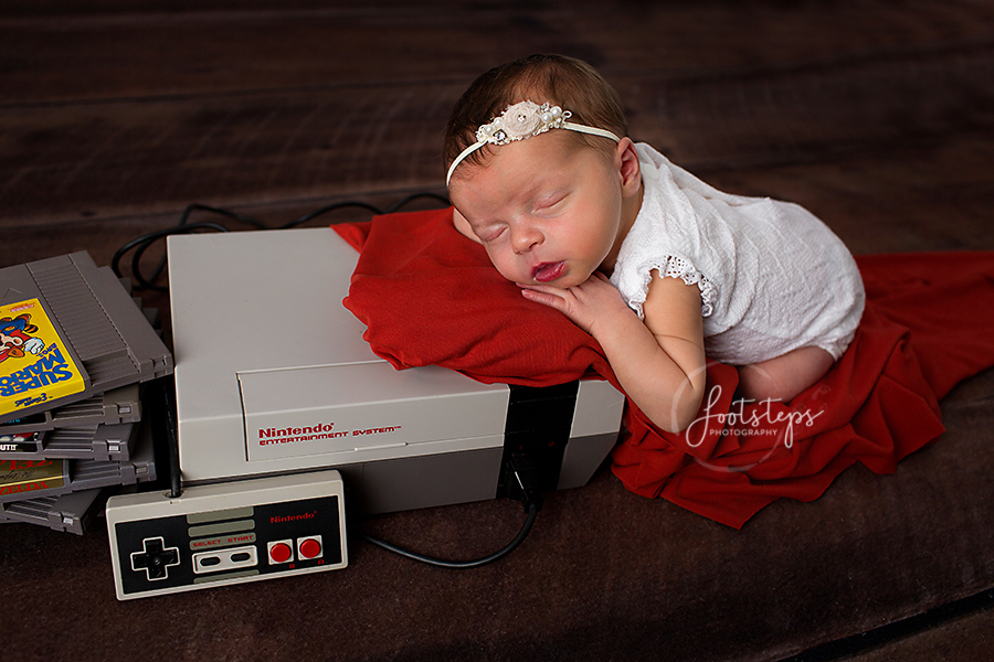 Newborn baby sleeping on Nintendo Console