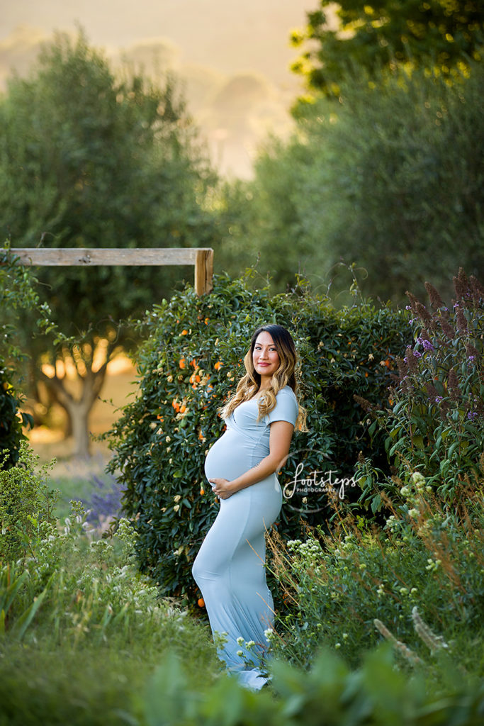 garden maternity session mom in blue gown