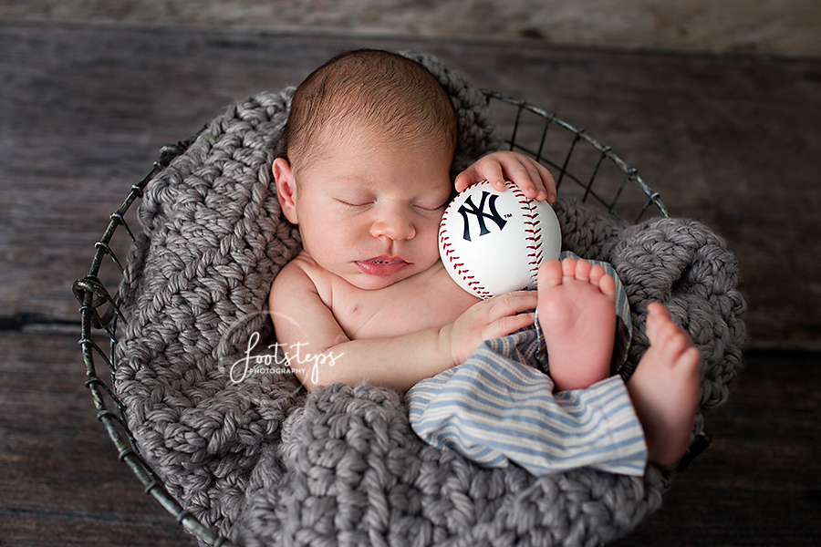 baby holding new york yankees baseball
