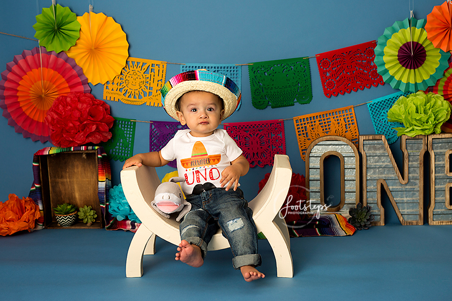 Baby celebrating his first birthday with footsteps photography