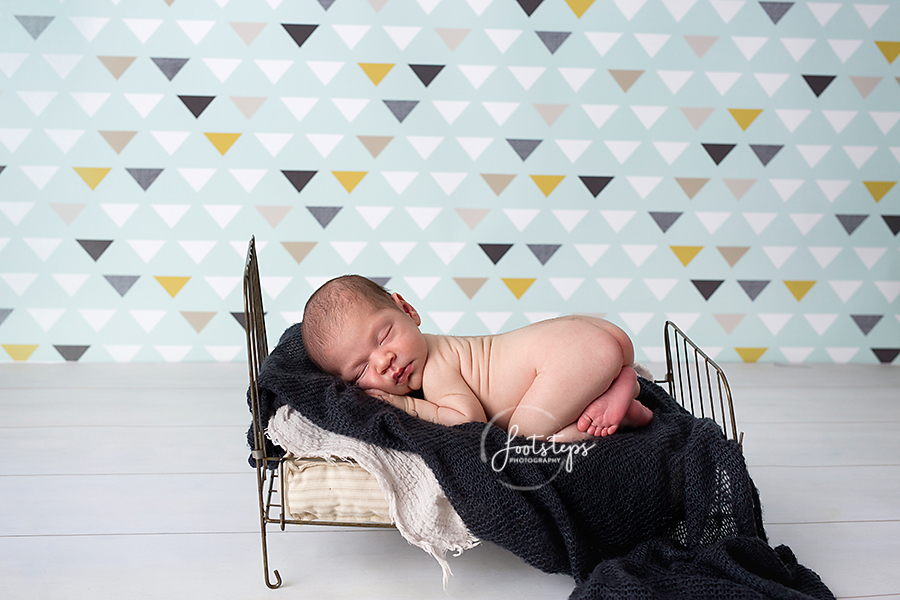 newborn sleeping on baby bed in vacaville studio